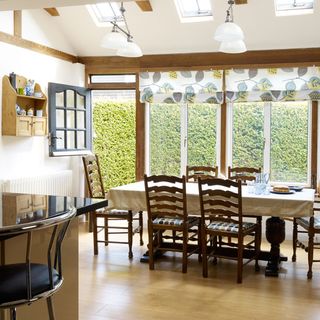 kitchen room with wooden flooring and dining table with chairs
