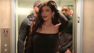 Kylie Jenner poses for the camera as she steps out of an elevator on Season 4 of The Kardashians.