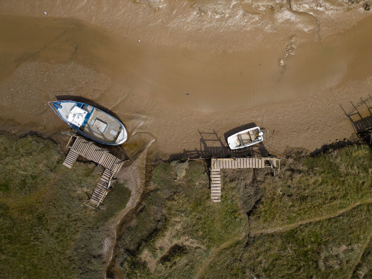 An aerial view of two moored boats