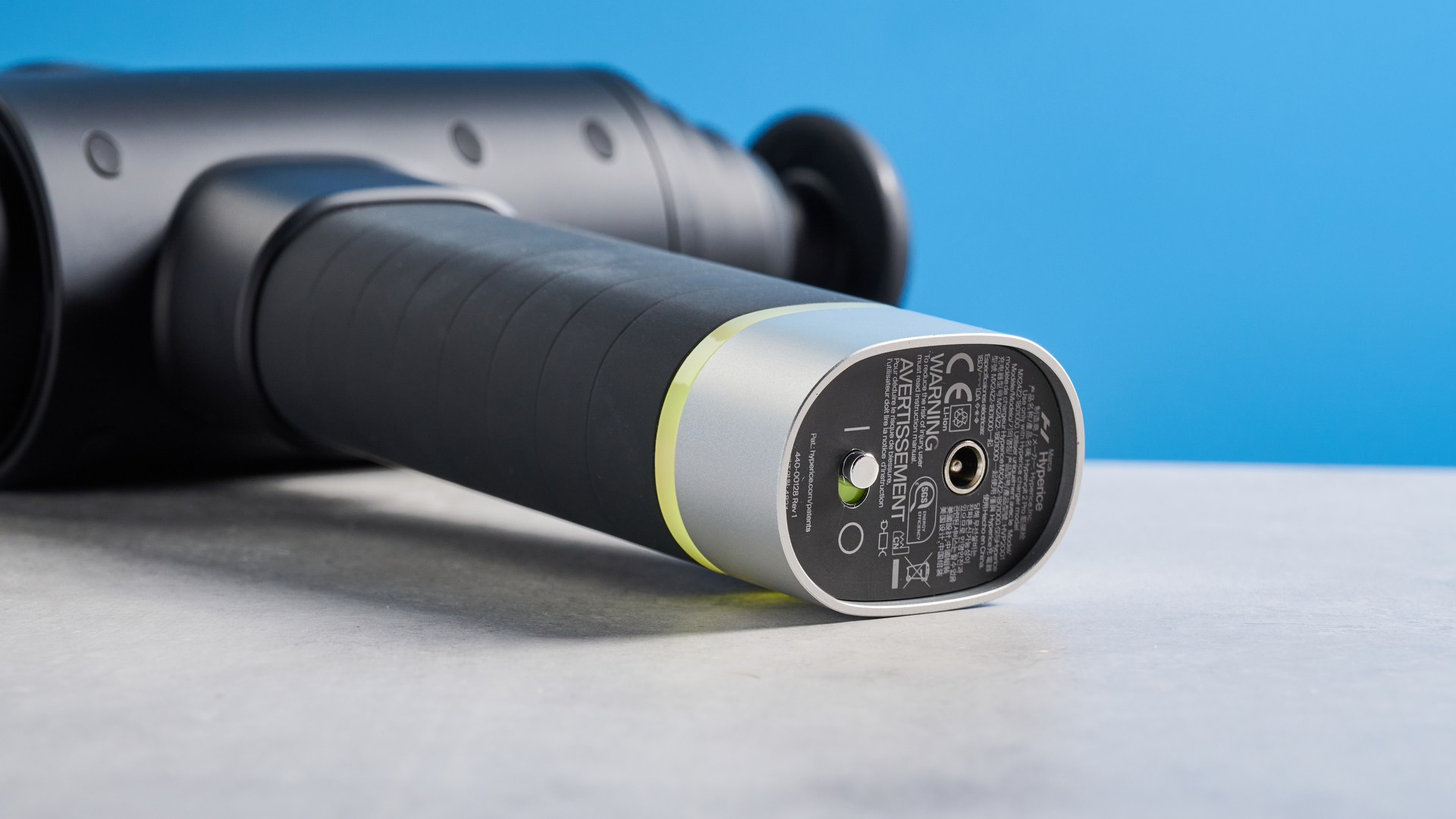 the hyperice hypervolt 2 pro massage gun with a long ergonomic handle and interchangeable massage head attachments