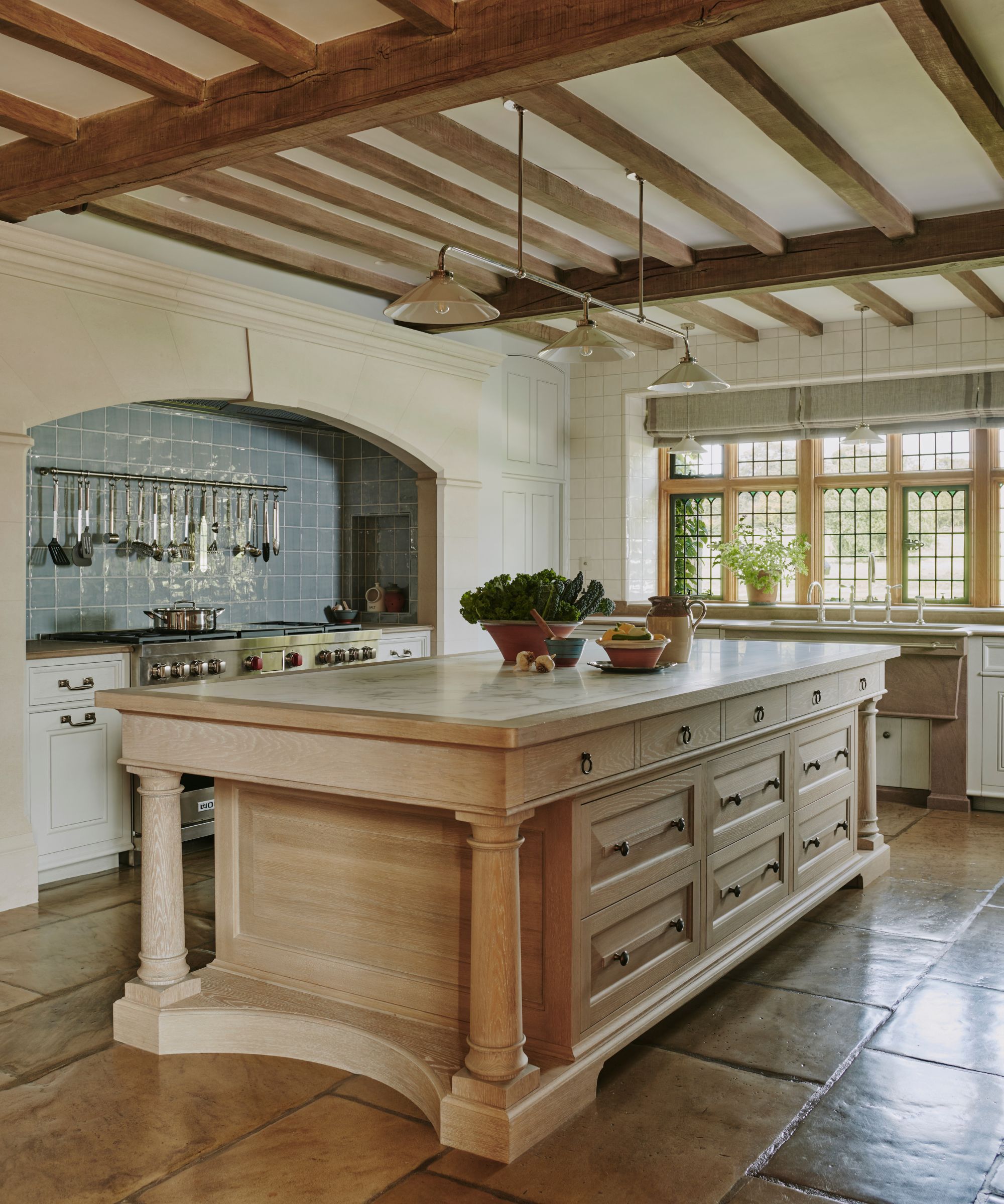 A traditional kitchen with a wooden island designed with multiple drawers for good storage