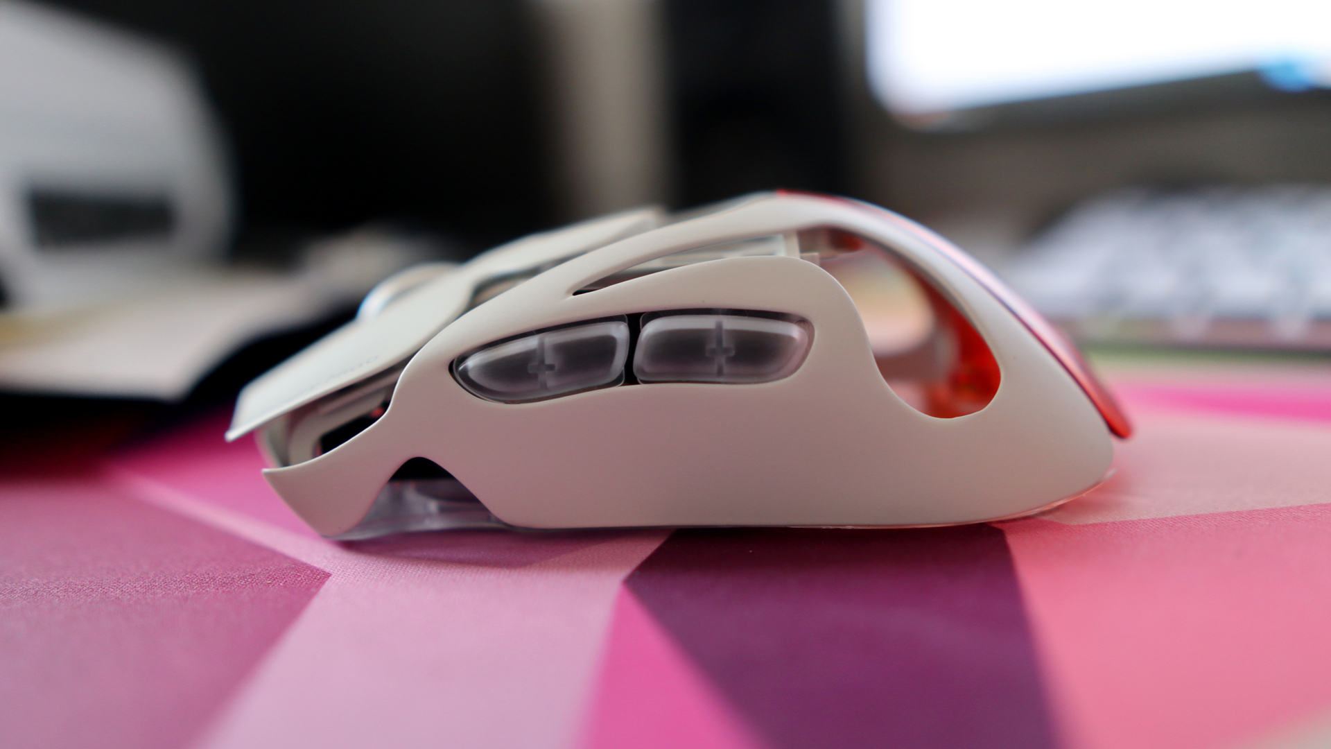 AngryMiao AM Infinity.97 gaming mouse on a colorful desk