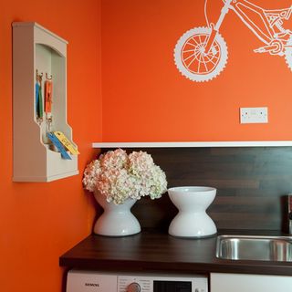 utility room with printed orange wall