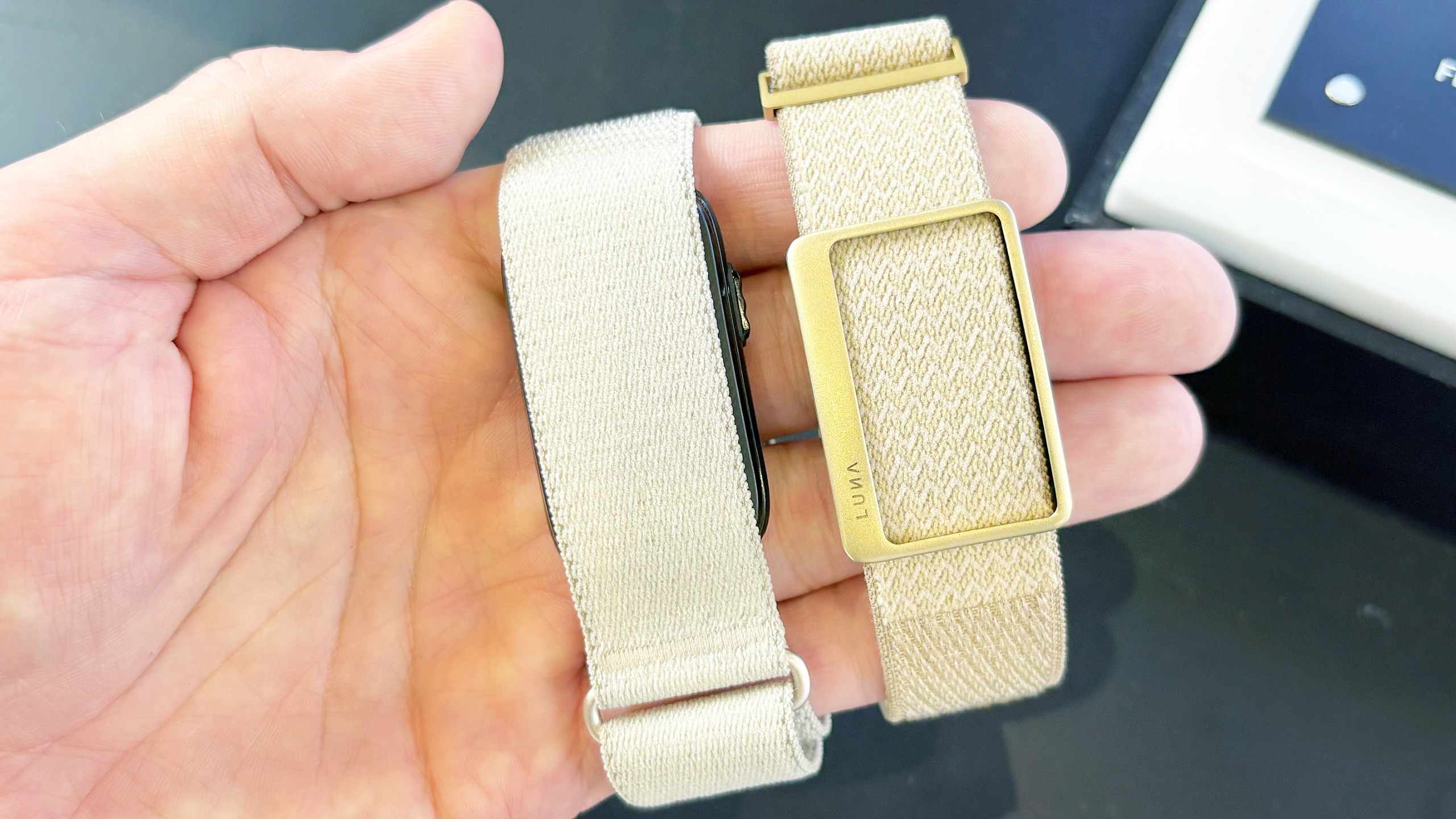 Close-up of the Garmin Cirqa screen-free tracker next to the Luna Band at IFA 2026 in Berlin