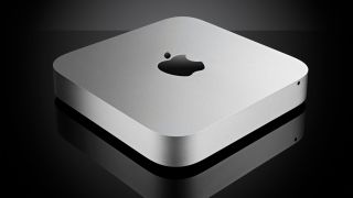 An Apple Mac Mini M2 angled towards the lens on a black background