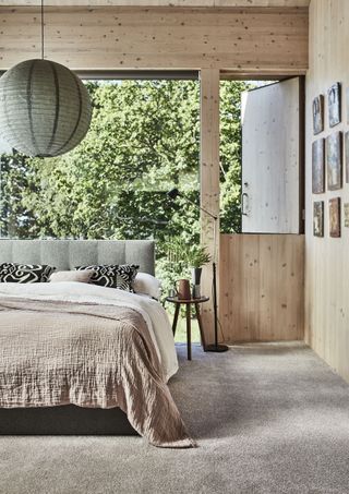 bedroom with large open windows and wood scheme by carpetright
