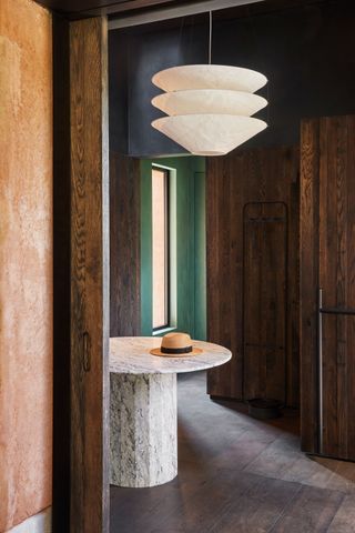 a dark wood entryway with a marble table