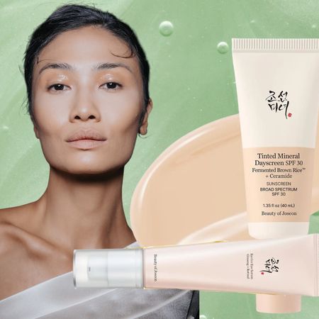 woman with glowing skin in a white off the shoulder top on a green background with beauty of joseon skincare next to her