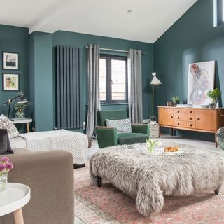 living room with teal green walls and wooden vanity