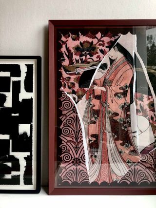 Red frame with painting with hints of red and pink, black frame for black and white painting