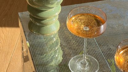 ikea disco ball table with cocktail glasses and vase on top