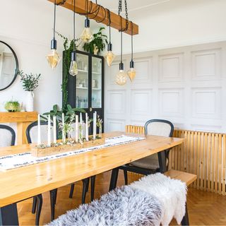 dining room with wooden dining table and bench with black chairs