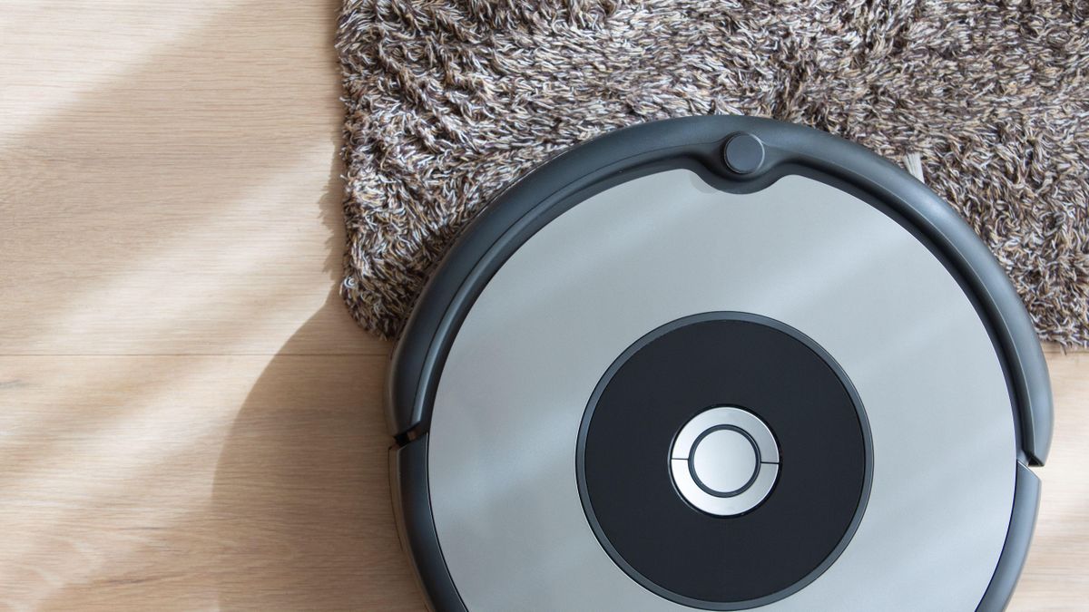 Robot vacuum cleaner on floor and carpet