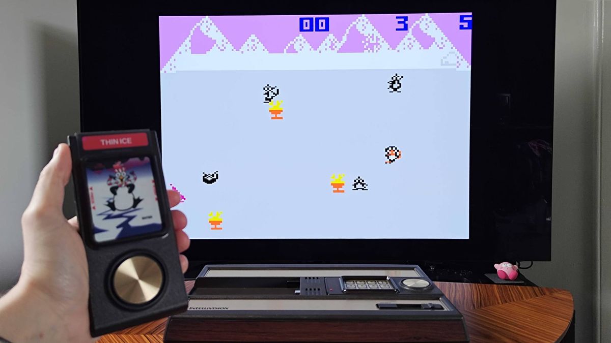 Hand holding Intellivision Sprint controller with Thin Ice gameplay on TV in backdrop.