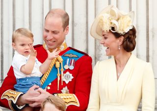 Prince William, Duke of Cambridge, Catherine, Duchess of Cambridge and Prince Louis of Cambridge watch a flypast from the balcony of Buckingham Palace