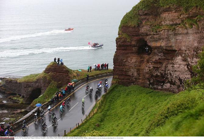 The peloton passes along the North Sea