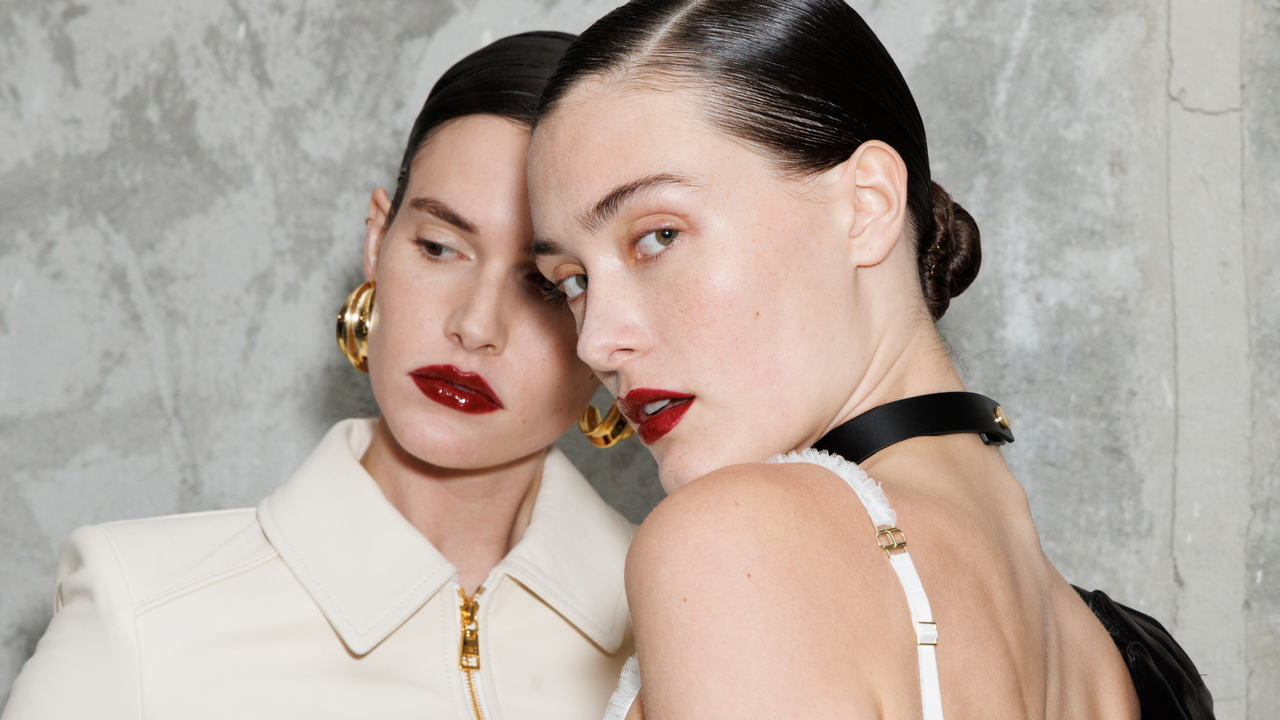 two models with beautiful skin and red lipsticks 