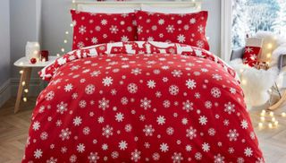 A red-and-white Christmas bedding set from Wayfair on a double bed.