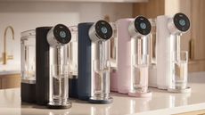 Four water filter systems on a light white kitchen counter. 