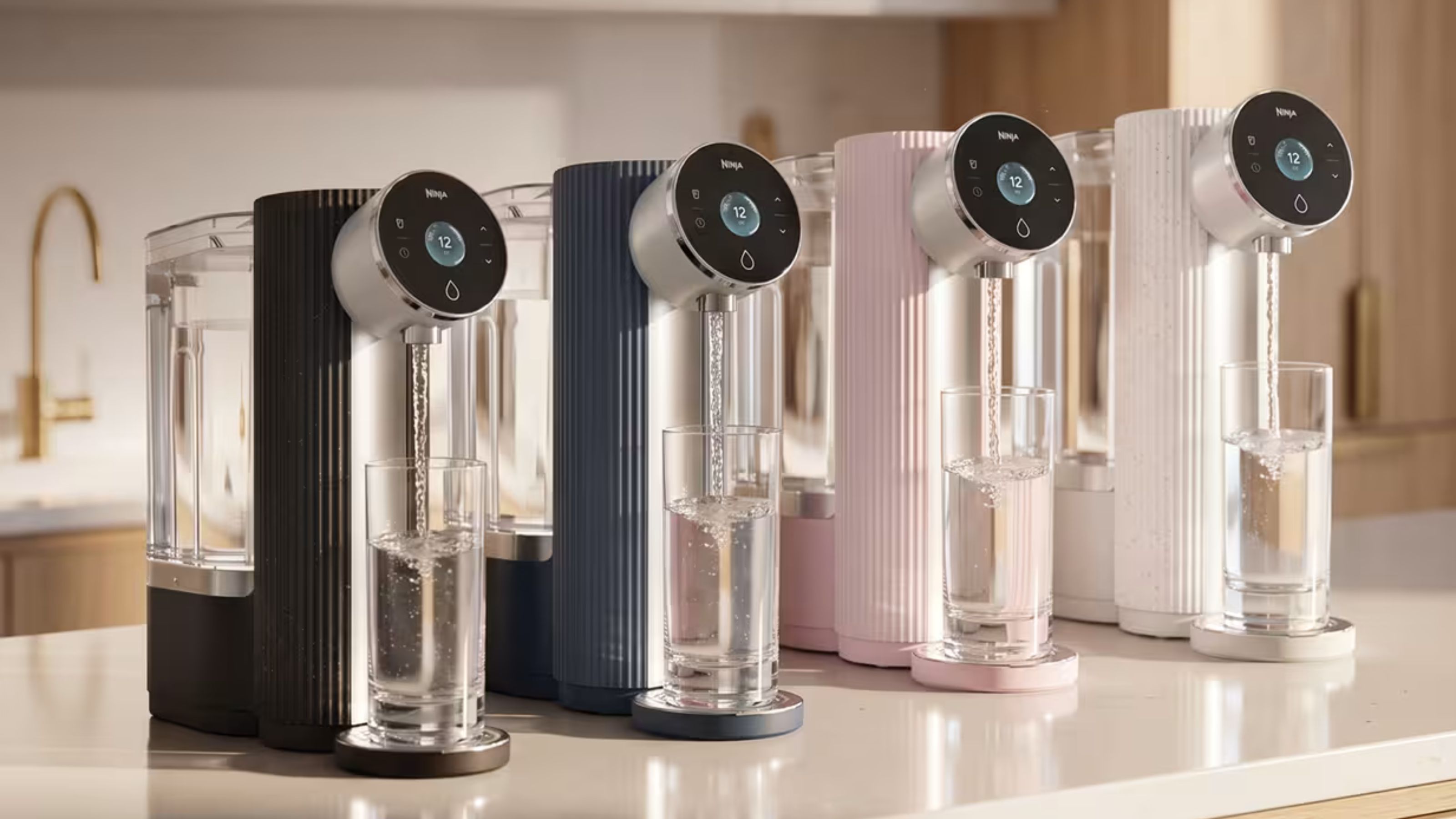 Four water filter systems on a light white kitchen counter. 