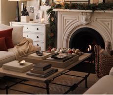 a living room with a festive garland and ornaments on a tray