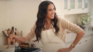 Meghan Markle stirs something on her stove as she laughs with guests on an episode of With Love, Meghan.