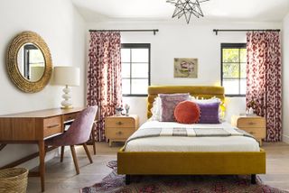 bedroom with yellow bed and pink curtains