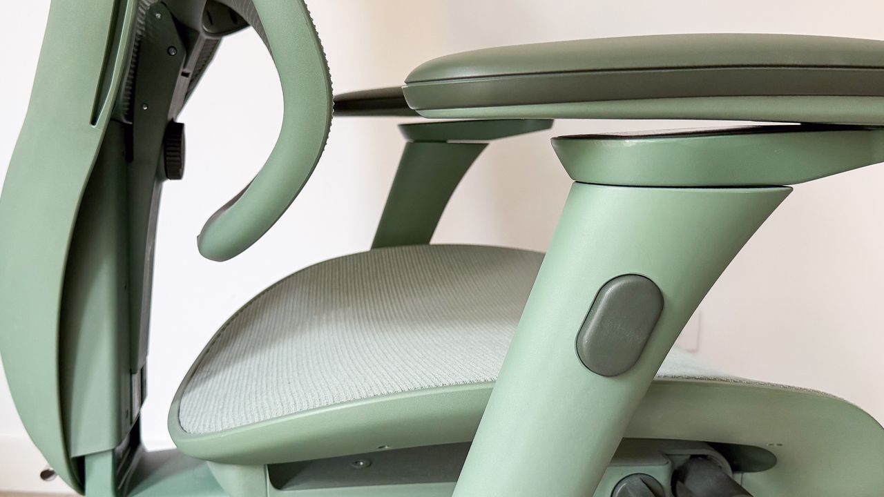Height adjustment button on the side of an armrest on the ErgoTune Vesby office chair