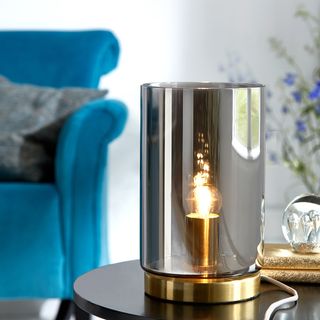 sidetable with blue armchair and lamp