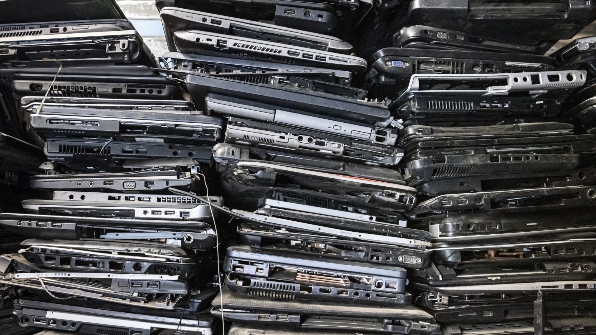 Old laptop casings are stacked on shelves in the local NGO Electronic Waste Initiative Kenya (E-WIK) workshop as the NGO collects electronic wastes to be processed, recycled, and repurposed