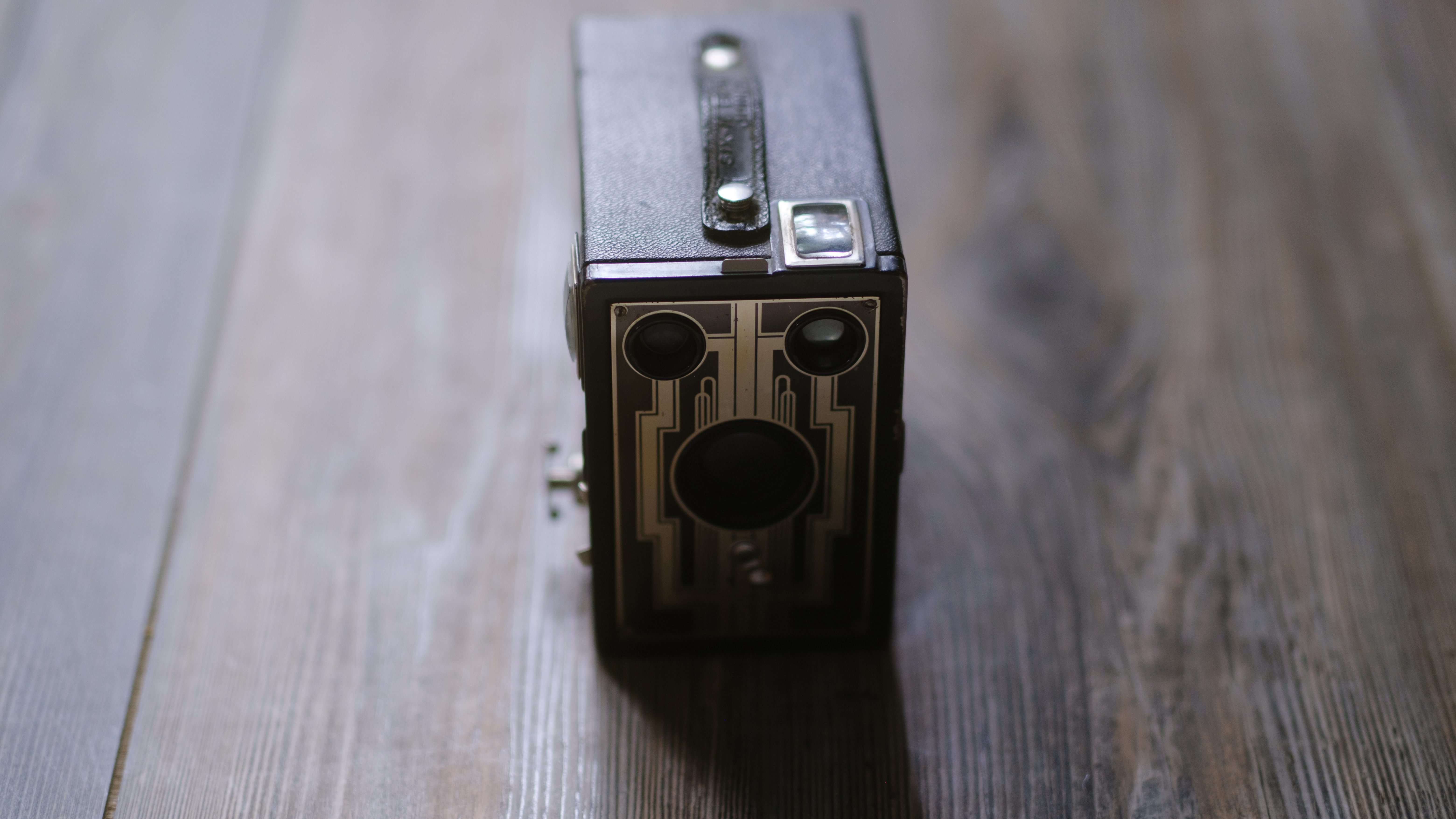 A photo of a vintage box camera taken under different lighting conditions