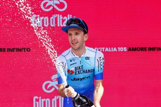  Simon Yates celebrates on the podium after winning the 14th stage of the Giro Italia 2022 