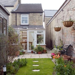 garden patio area with lawn and hanging plant pots