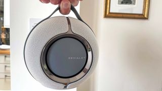 Devialet Mania held aloft by reviewer's fingers