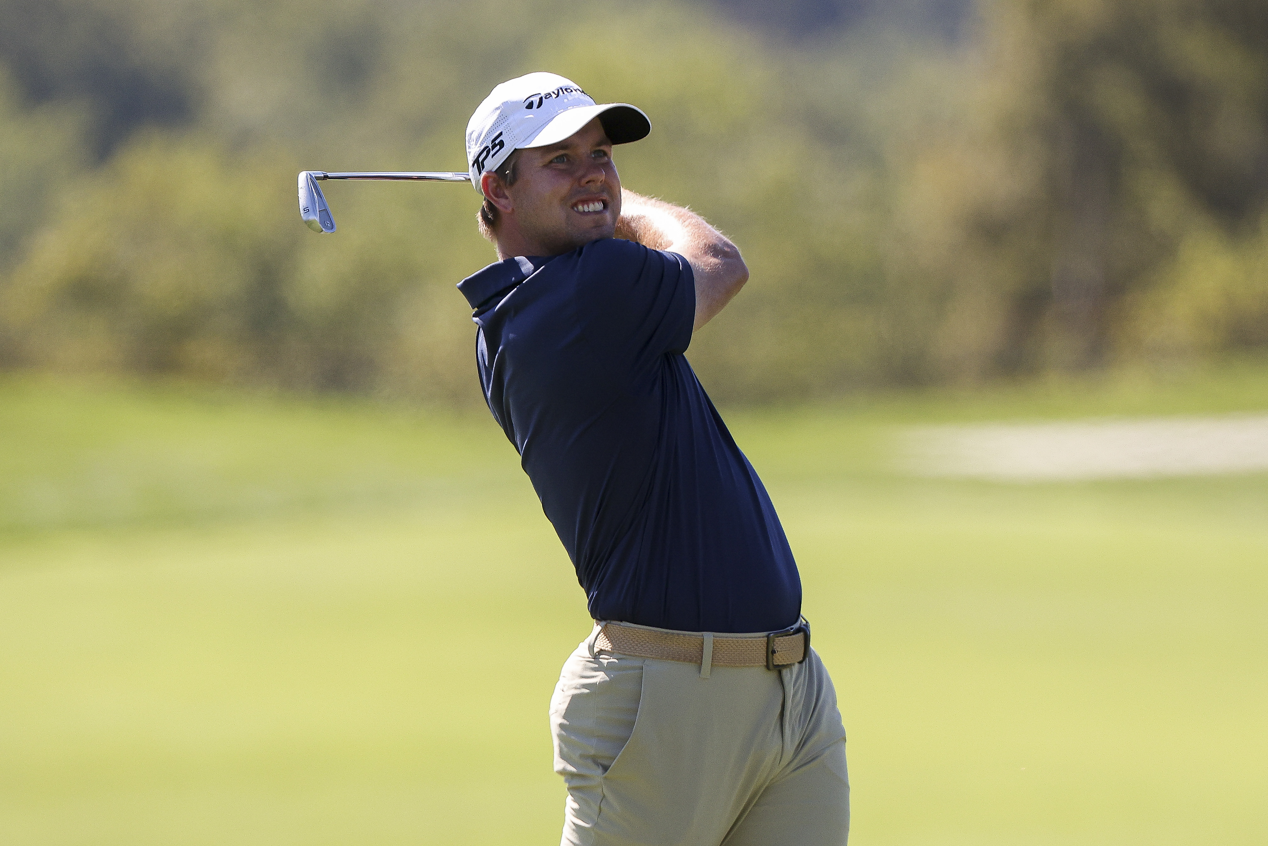 Pierceson Coody holds his finish on an iron shot