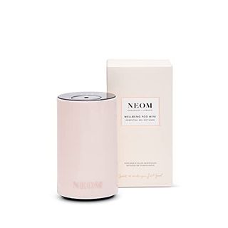 Neom – Portable Wellbeing Pod Mini Essential Oil Diffuser in Nude. It's small and round, much like the size and shape of a 330ml can of carbonated drink