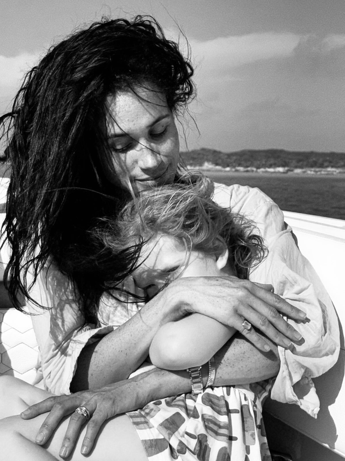 Princess Lilibet sitting on Meghan Markle's lap on a boat