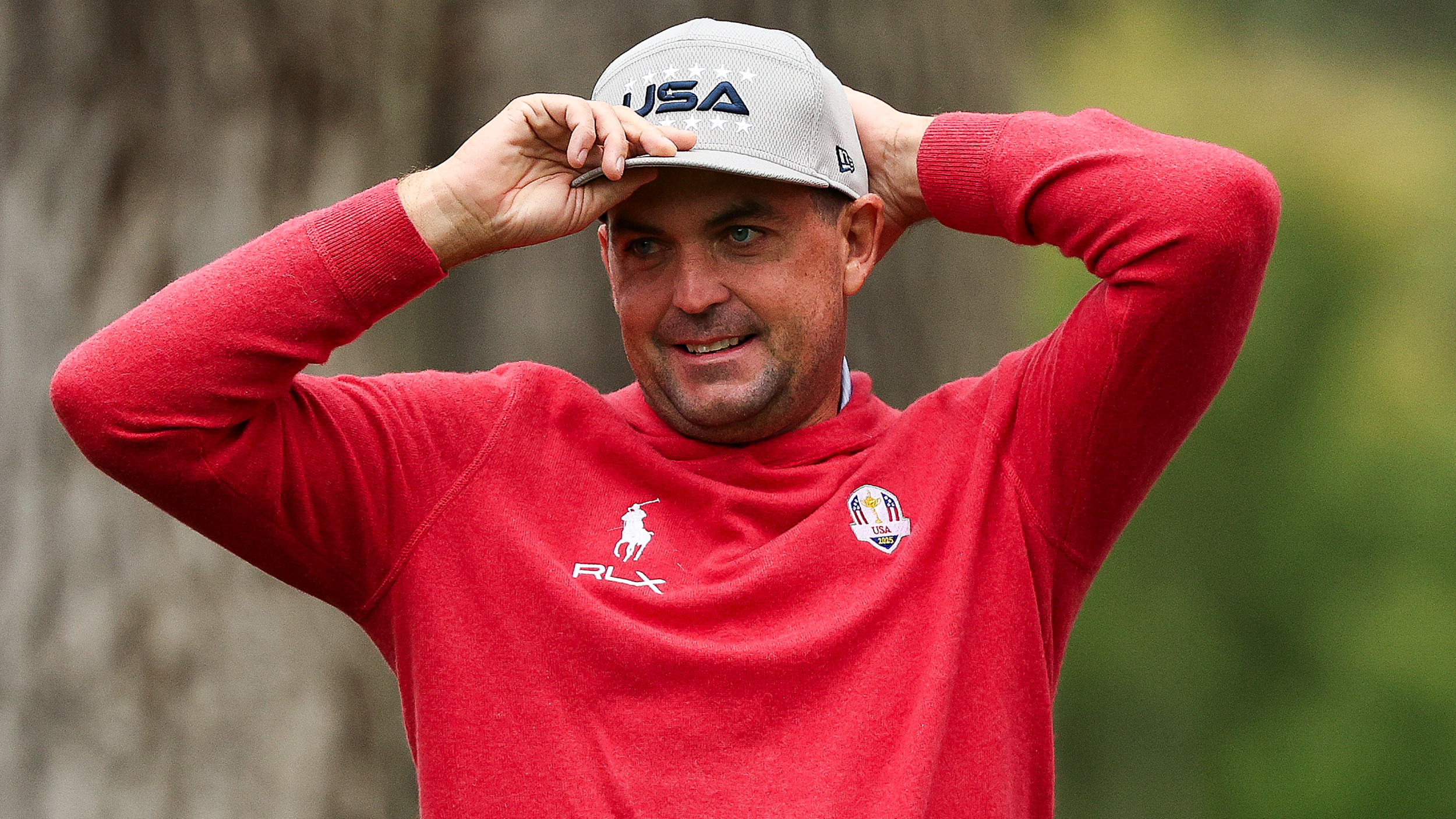 Keegan Bradley adjusts his hat 