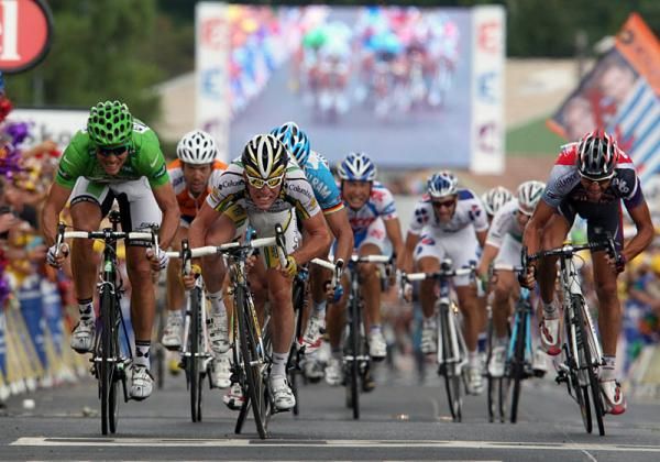 Seeing double....specators along the finishing straight witness Mark Cavendish live and on-screen winning stage 19.