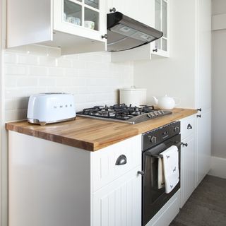 kitchen with wooden cabinet and white tiles