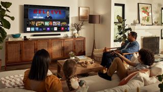 A family in a living room watching the Vizio V-Series.