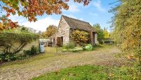 A barn with wooden cladding on a rural plot