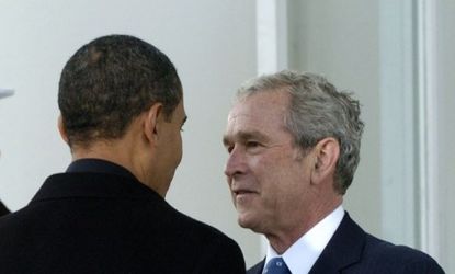 Bush welcomes then President-elect Barack Obama into the White House with a collegiate handshake.