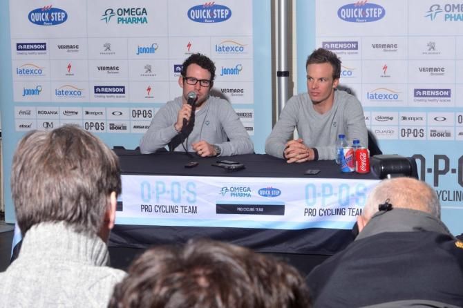 Iljo Keisse looks on while Mark Cavendish answers questions