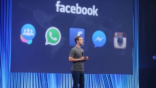 Mark Zuckerberg speaking onstage, Facebook brand logo appears behind him