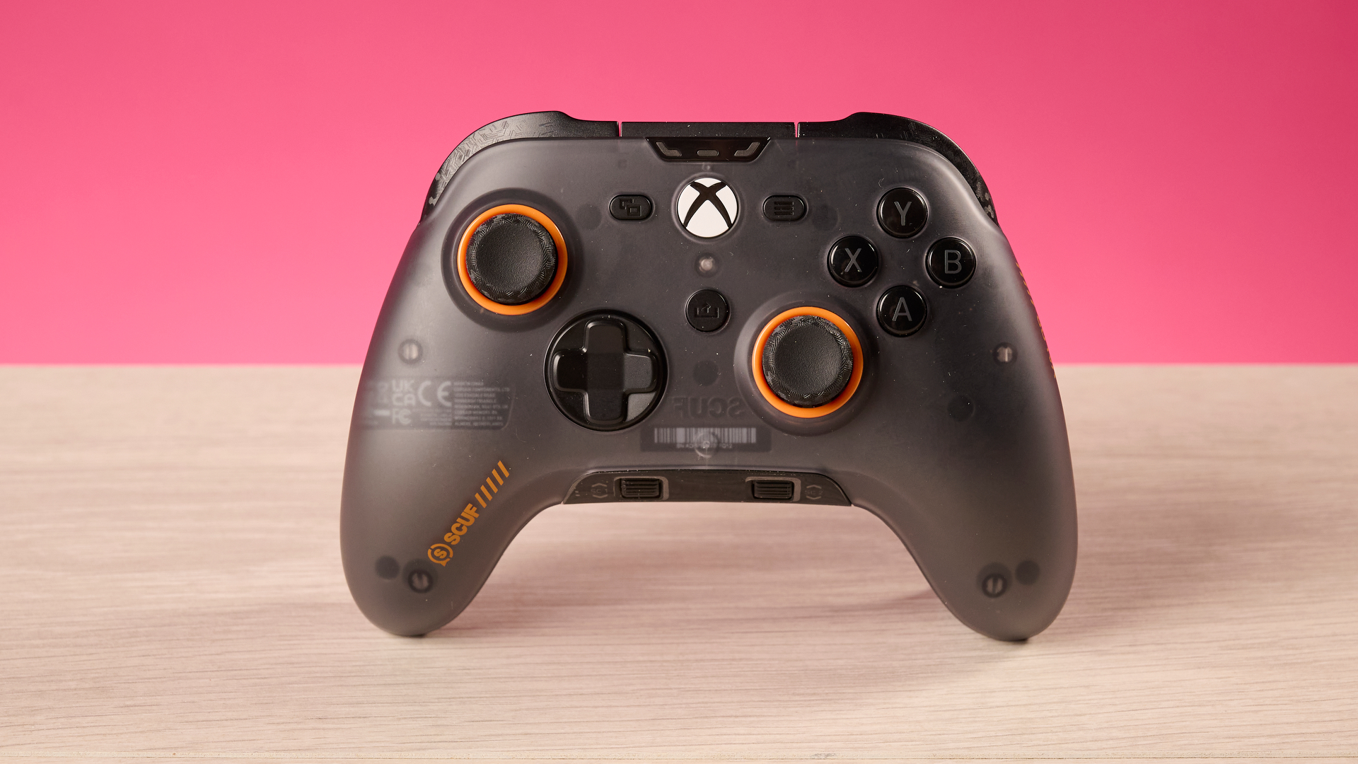 The Scuf Valor Wired with TMR in front of a pink background.