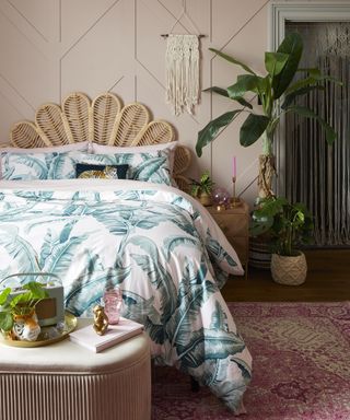 Rattan headboard with palm print bedding in bedroom by Dunelm
