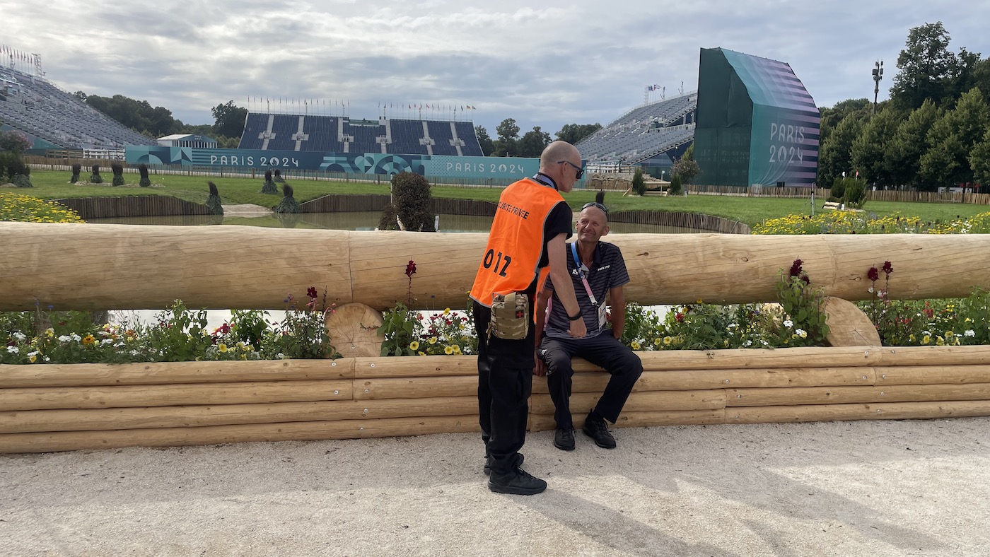 Coure designer Pierre le Goupil with a security guard next to a cross-country fence