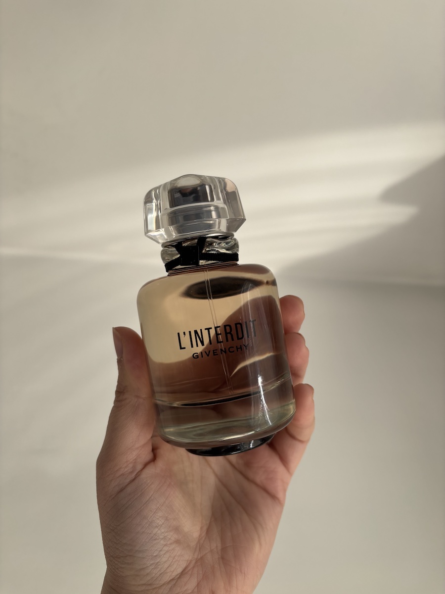 Mica Ricketts holding Givenchy L'Interdit EDP