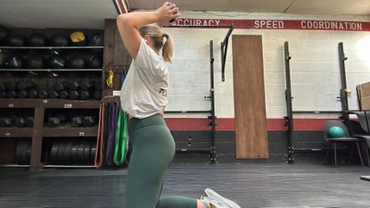 Woman doing dumbbell halo exercise